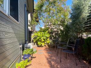 a patio with chairs and plants next to a building at Kiwi House Tokoname VACATION STAY in Tokoname