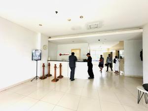 um grupo de pessoas em pé em um corredor em RedLiving Apartment @ Dramaga Tower by Liana Room em Bubulak 3