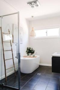 a bathroom with a bath tub and a ladder at Live in the Heart of Mudgee at Fairbairn Cottage in Mudgee