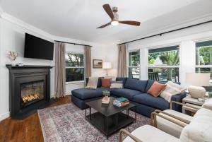 a living room with a blue couch and a fireplace at Grape Escape Inn & Suites in Lodi