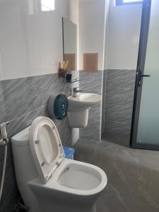 a bathroom with a toilet and a sink at Lak village in Lien Son