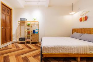 um quarto com uma cama e piso em madeira em Pasteur Home 3 em Ho Chi Minh