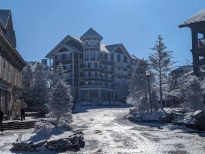 a large building with a clock tower on it at Evergreen Escape At Snowshoe in Snowshoe