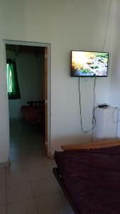 a flat screen tv hanging on the wall of a room at Alberto Beach in Las Grutas