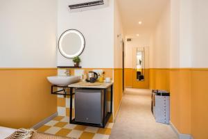 a bathroom with a sink and a mirror at Upstairs Downstairs CoLiving Bukit Bintang in Kuala Lumpur
