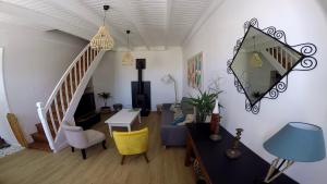 a living room with a staircase and a mirror at La cousinade No in Noirmoutier-en-l'lle