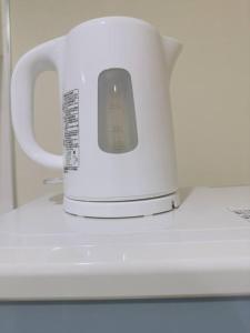 a white appliance sitting on top of a microwave at 100m from nearest bus stop/8 mins to Ikebukuro sta in Tokyo