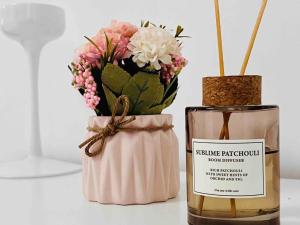 a vase with flowers next to a bottle of perfume at Iconic location only 500 meters to The Louvre in Paris