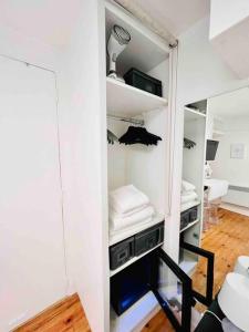 a room with a closet with white walls at Iconic location only 500 meters to The Louvre in Paris