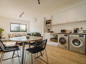 a kitchen with a table and chairs in a room at Le Jardin in George