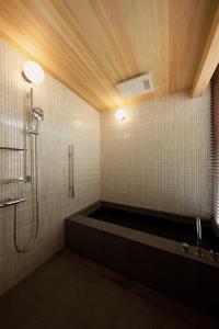 a bathroom with a shower and a bath tub at tamao-たま靑- in Kyoto