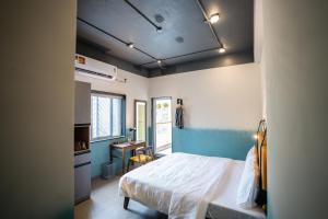 a bedroom with a bed and a desk in it at Draper Startup House for Entrepreneurs Hyderabad in Hyderabad