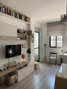 a living room with a flat screen tv on a wall at Apto residencial piscina centro-Parking in Jaén