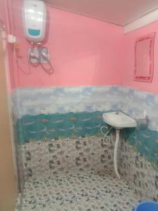 a bathroom with a sink in a pink wall at Eden Homestay Sittong in Kurseong