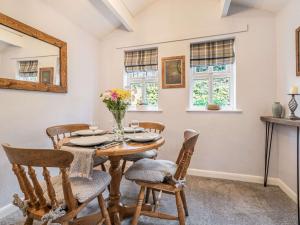 a dining room with a wooden table and chairs at 2 Bed in Bouth LCC02 in Bouth