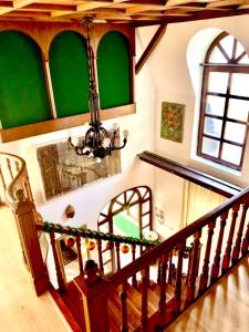 a staircase in a house with a green wall at Villa Butterfly in Budapest