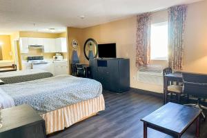 a hotel room with two beds and a kitchen at Garden Inn & Suites in Rome