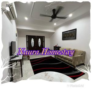 a living room with a couch and a ceiling fan at Naura Roomstay in Sungai Petani +3 photos