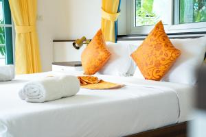 a hotel room with two beds with towels and pillows at ฺBaan Waru seaview villa in Ban Kata