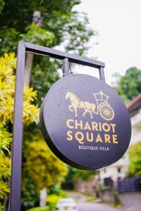 um sinal para um quadrado de carruagem com um cavalo sobre ele em Chariot Square em Kandy