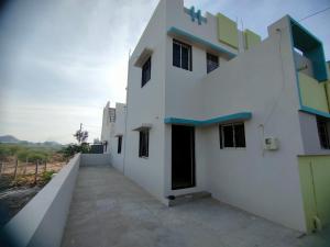 a white building with a walkway in front of it at My Nest - Best Homestay for Peaceful Stay with Comfort in Bhuj