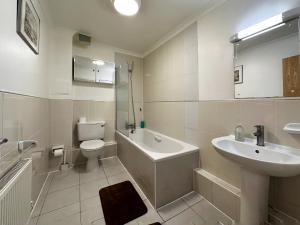 a white bathroom with a sink and a toilet at Tina’s Place in Tower Hill in London