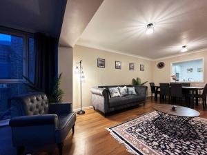 a living room with a couch and a table at Tina’s Place in Tower Hill in London