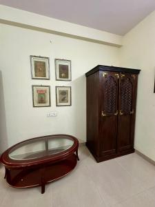 a room with a wooden cabinet and a glass table at Supyar Mahal in Jaipur