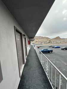 a balcony of a building with cars parked in a parking lot at Dream Inn in Tonopah