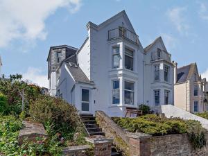 a large white house with stairs in front of it at 4 Bed in Fowey 82152 in Fowey