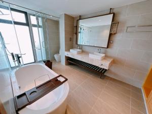 uma casa de banho com um WC, um lavatório e um espelho. em Phoenix Pool Villa Cam Ranh em Cam Ranh