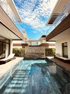 a swimming pool in the middle of a house at Phoenix Pool Villa Cam Ranh in Cam Ranh