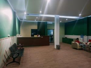 a woman sitting in a waiting room in a hospital at Quanza Hotel in Banda Aceh