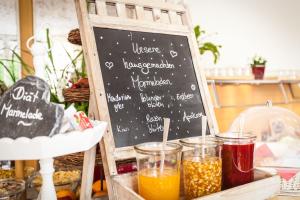 a chalkboard with some drinks on a table at Hotel Deutscher Hof in Trier
