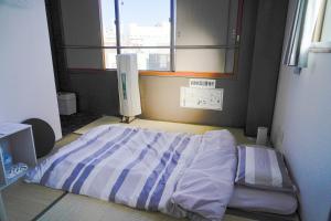 a hospital room with a bed and a window at ゲストハウス CYCLE&STAY in Tokushima +16 photos