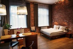 1 dormitorio con cama y pared de ladrillo en Apartamenty Straszewskiego en Cracovia