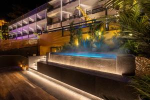 a building with a swimming pool at night at Hi Room in Trento