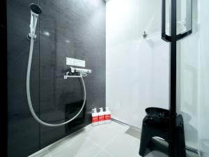 a bathroom with a shower with a glass door at Rakuten STAY Fukuoka Yakuin Family Room in Fukuoka