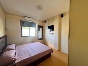 Postel nebo postele na pokoji v ubytování APARTELLE BORACAY