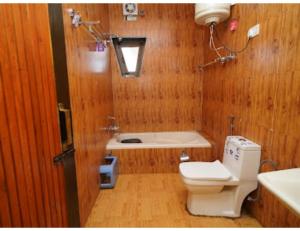 La salle de bains est pourvue de toilettes et d'une baignoire. dans l'établissement Paradise kabins, srinager J&K, à Telbal