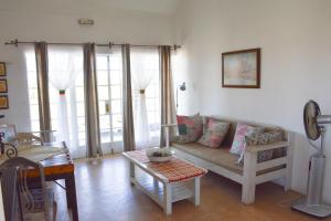 a living room with a couch and a table at Alte Kalkoefen Lodge in Simplon