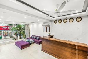 a lobby with purple chairs and a reception desk at ELC Beach Hotel in Da Nang