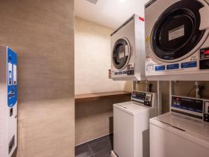 two pictures of a laundry room with a washer and dryer at Music Hotel Koza by Coldio Premium in Okinawa City