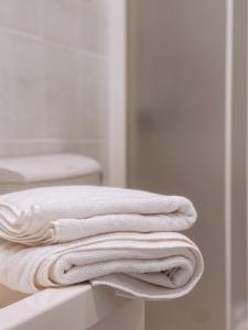 a stack of white towels sitting on a bathroom counter at Adriana Zaton in Zaton