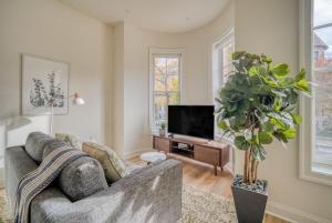 a living room with a couch and a tv at Dupont Circle 1br w wd nr metro station WDC-747 in Washington, D.C.