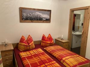 a hotel room with two beds and a mirror at Bauernhof Vordergrub in Scheffau am Wilden Kaiser