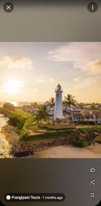 a picture of a lighthouse on the beach at Villa Sea View in Galle