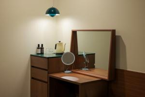 a bathroom with a vanity with a mirror and a sink at Jeonju AANK Hotel in Jeonju