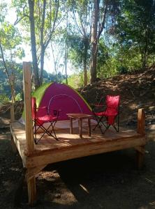 a tent with two chairs and a table in front of it at Eastdee Camping Ground in Lidlidda