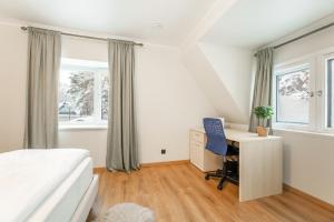 a bedroom with a bed desk and a window at Cozy private house in Nõmme in Tallinn
